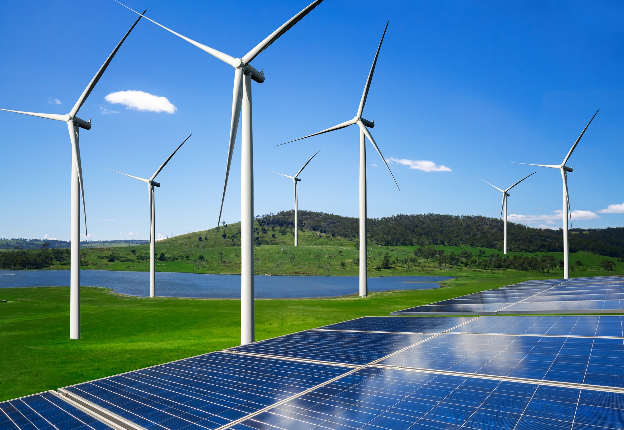 Solar panels and wind turbines producing renewable power