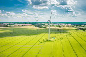 wind-turbines-on-golden-green-field-in-summer-aer-2026-01-09-06-44-07-utc-1